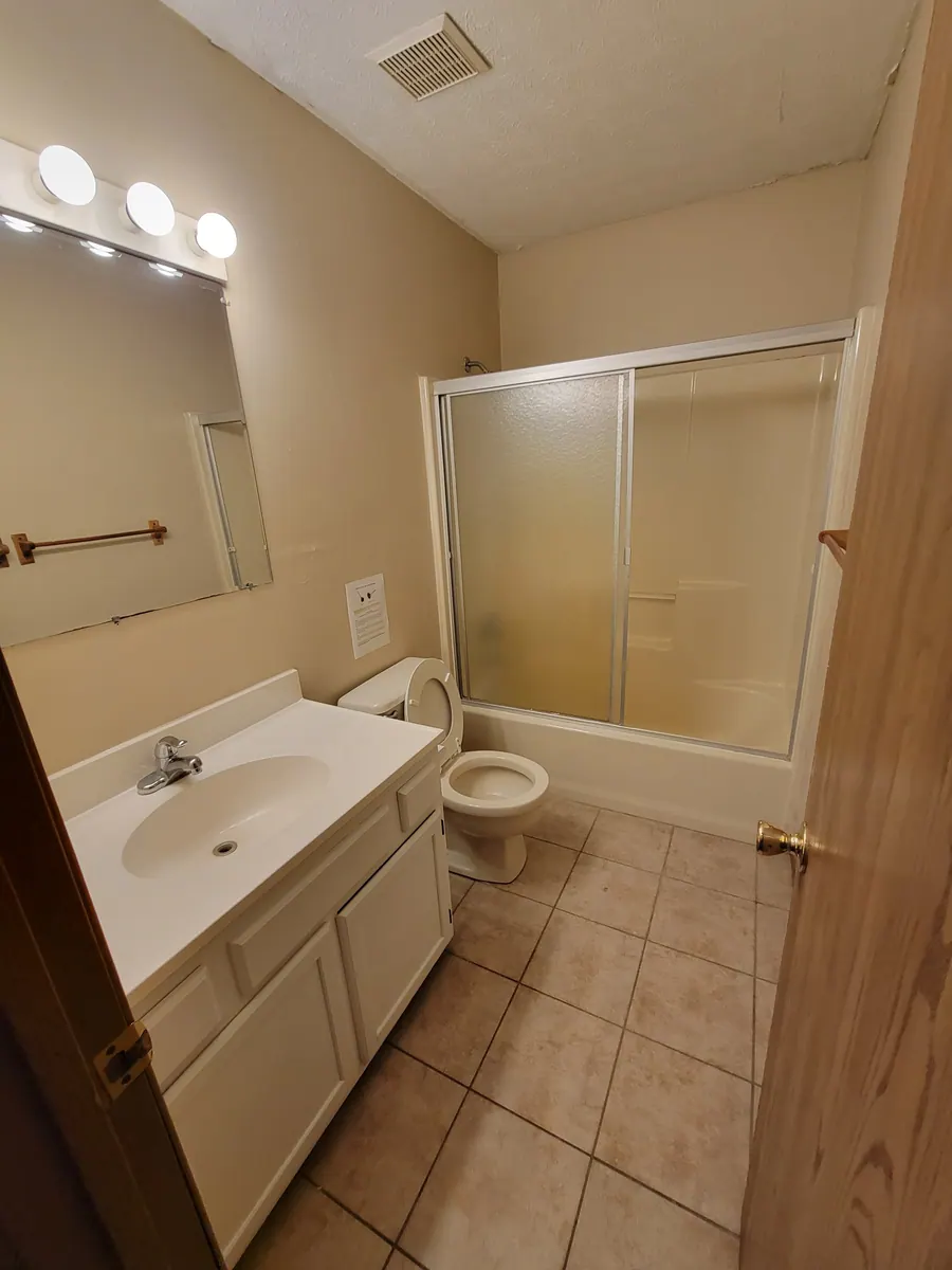 Deluxe bathroom with a vanity and enclosed bathtub