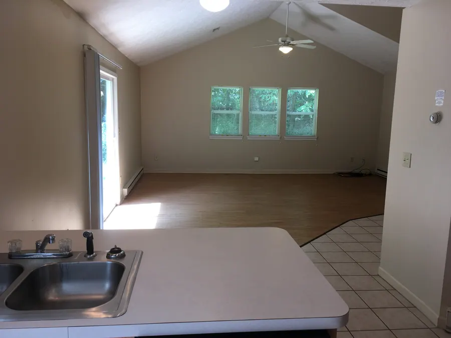 Premier interior with a vaulted living area and three windows, viewed from the kitchen