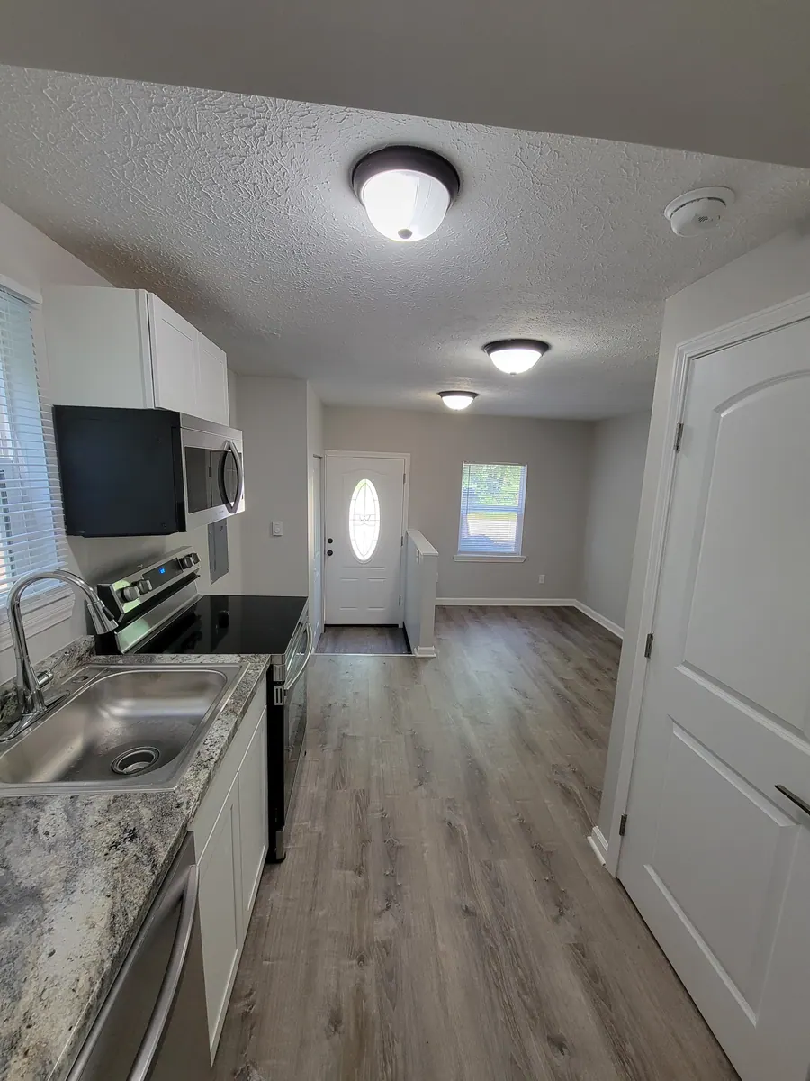View from the studio kitchen toward the open living space and entry