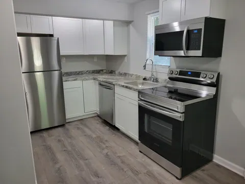Studio kitchen with white cabinets and stainless-steel appliances